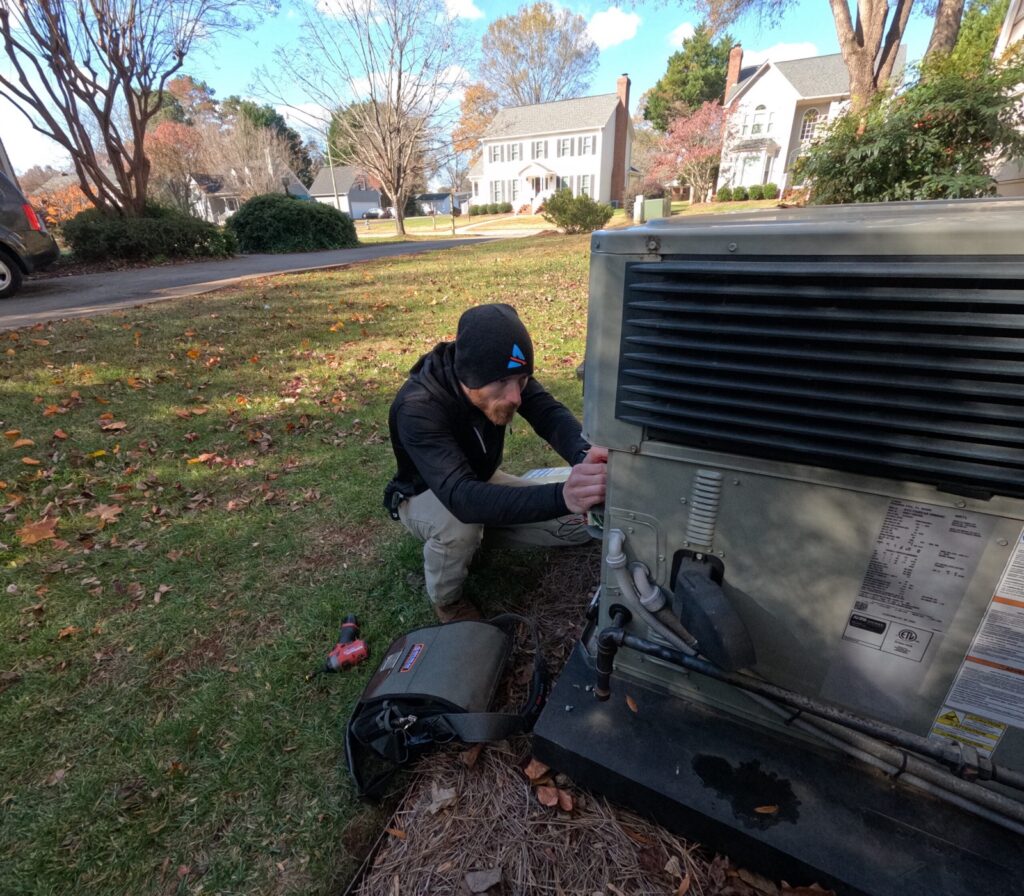 Atlas technician diagnosing an outdoor packaged heating and cooling unit at a home