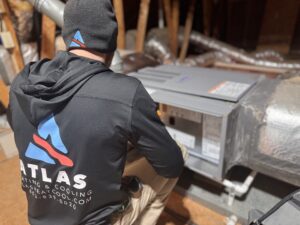 Atlas Heating and Cooling team servicing an HVAC system