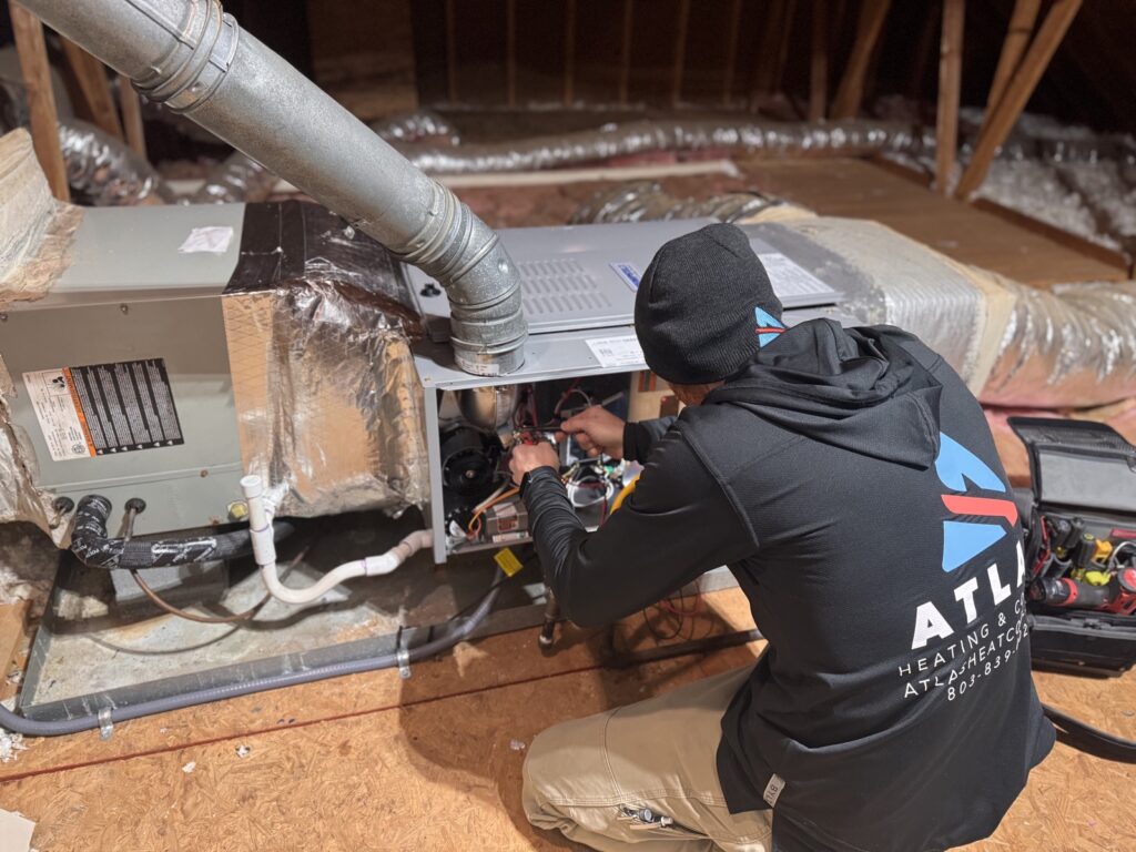 Atlas Heating & Cooling technician performing HVAC service work